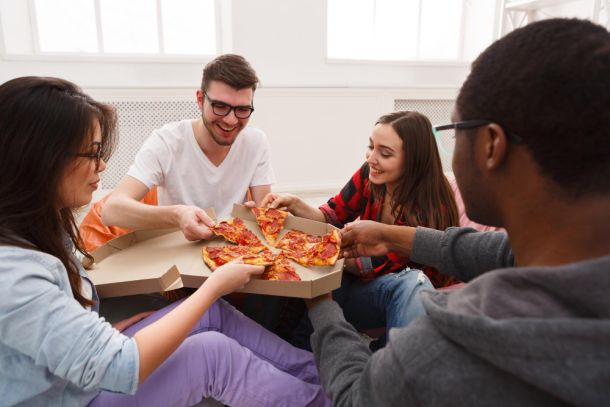 people eating pizza at home